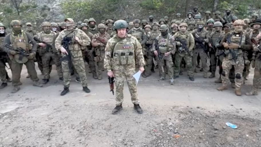 Yevgeny Prigozhin makes a statement as he stand next to Wagner fighters in an undisclosed location in the course of Russia-Ukraine conflict, in this still image taken from video released May 5, 2023. 