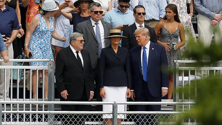 Donald Trump stands next to Melania in bleachers for his son Barron’s graduation.