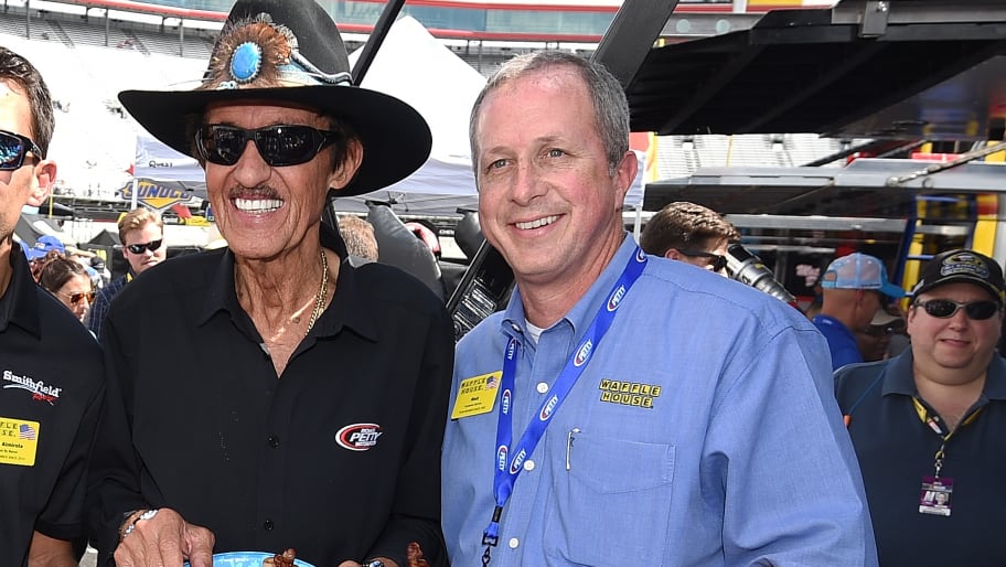 Aric Almirola, driver of the #43 Waffle House Ford, team owner Richard Petty and Walt Ehmer, CEO of Waffle House, pose for a photo.