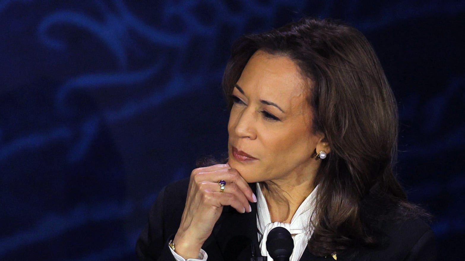 Conspiracy theorists falsley claimed Kamala Harris wore secret earpieces during her debate against Donald Trump.