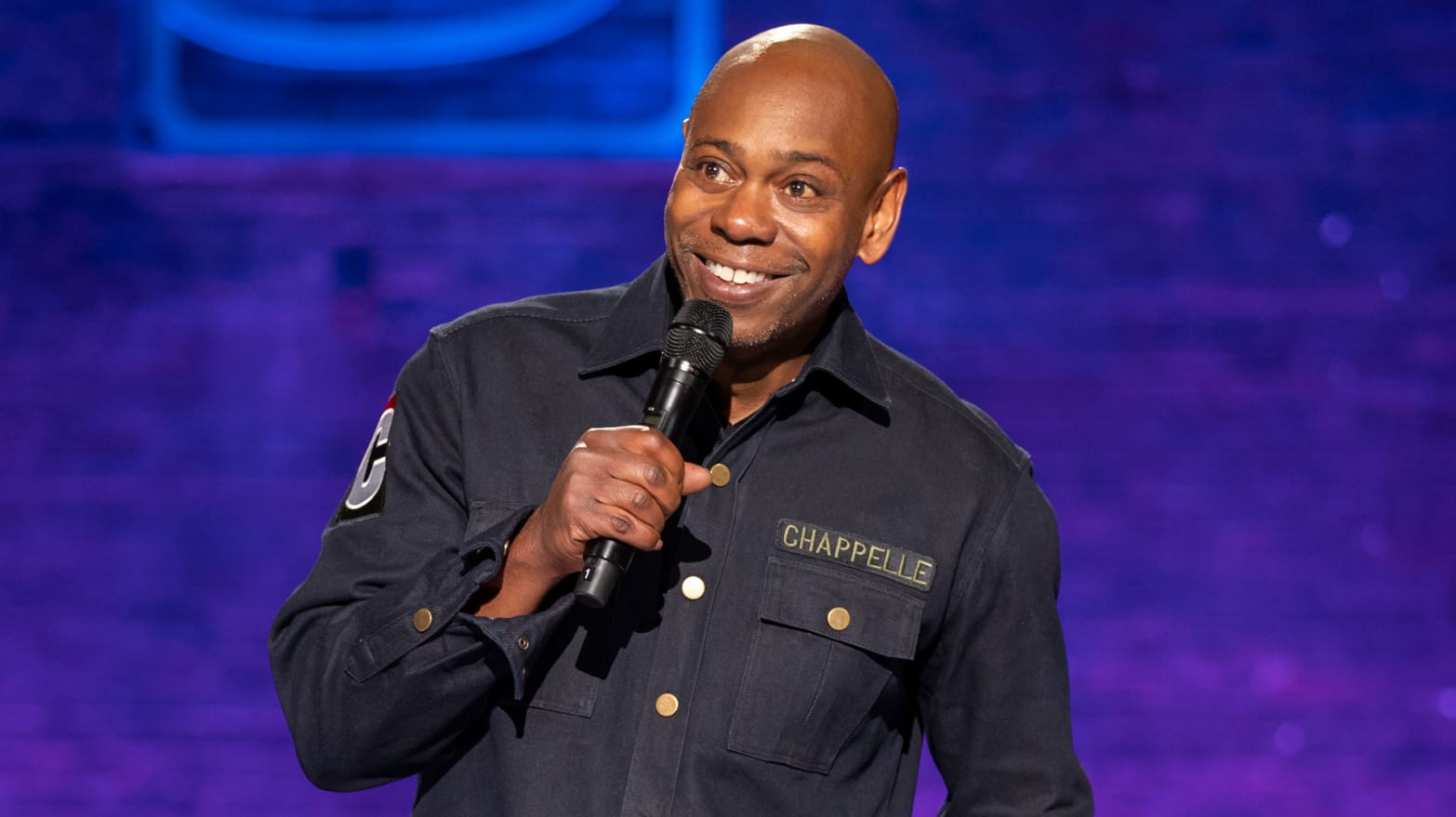 Photograph of Dave Chappelle performing standup in his Netflix special, The Dreamer