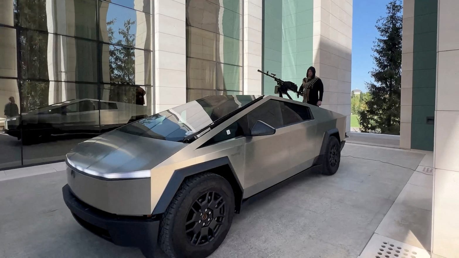 Chechen President Ramzan Kadyrov is seen atop what is said to be a Tesla Cybertruck equipped with a machine gun.