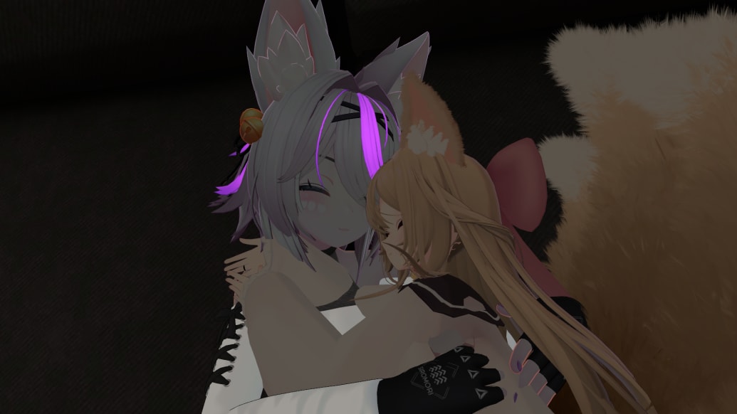 Two digital avatars fall asleep and snuggle up on VRChat.