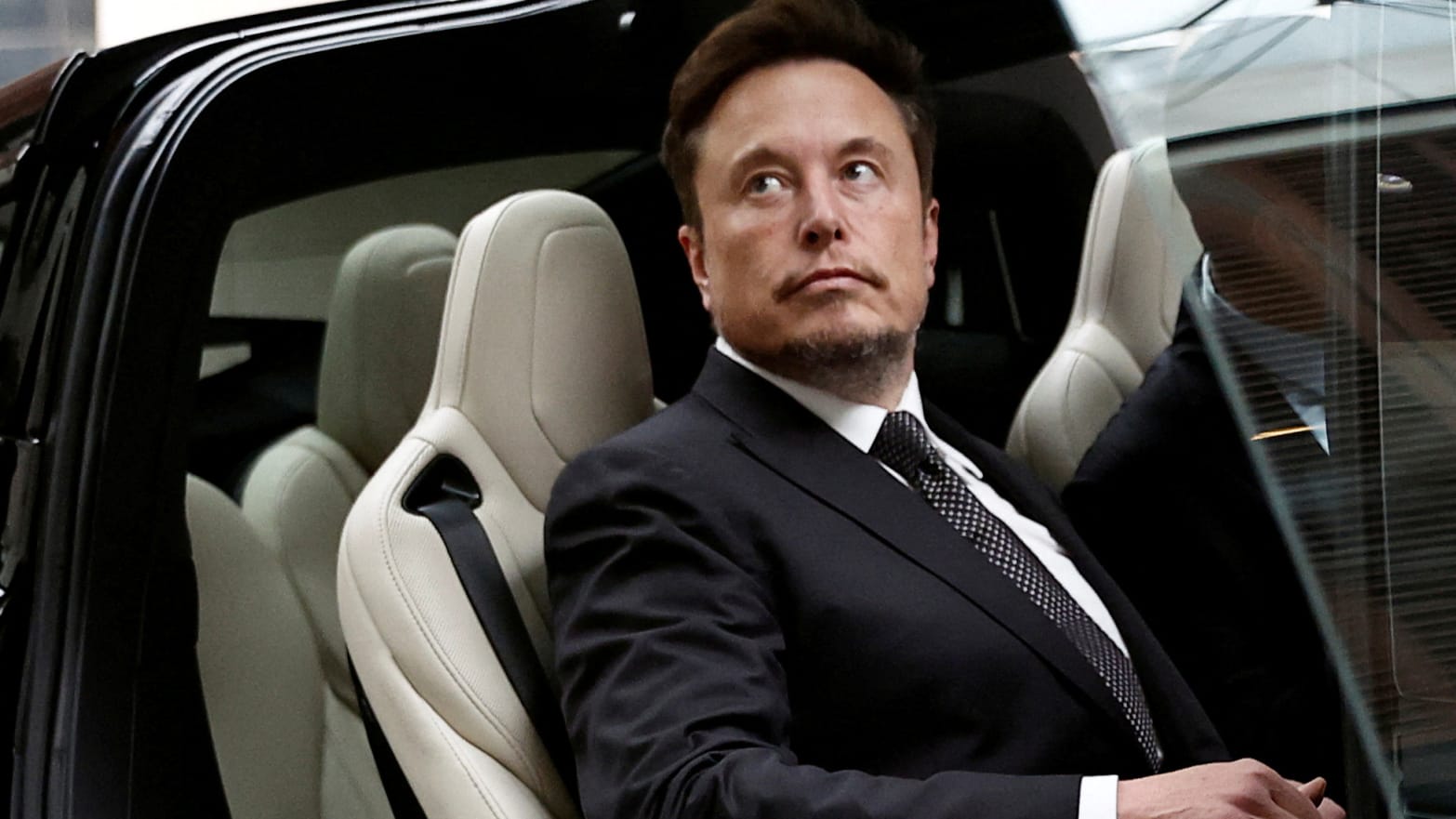 Elon Musk gets in a Tesla car as he leaves a hotel in Beijing, China May 31, 2023.