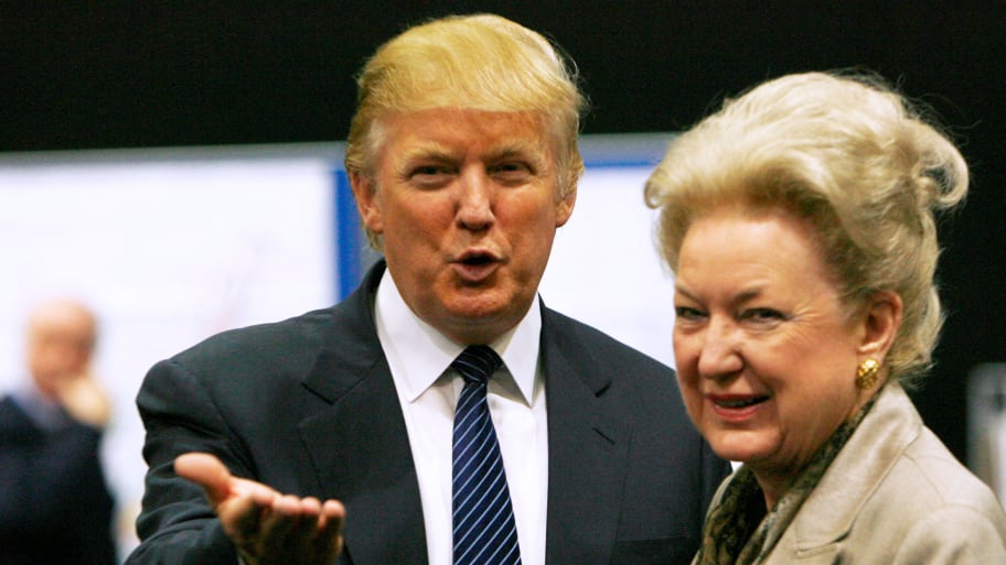 Donald Trump (L) gestures as he stands next to his sister Maryanne Trump Barry, during a break in proceedings of the Aberdeenshire Council inquiry