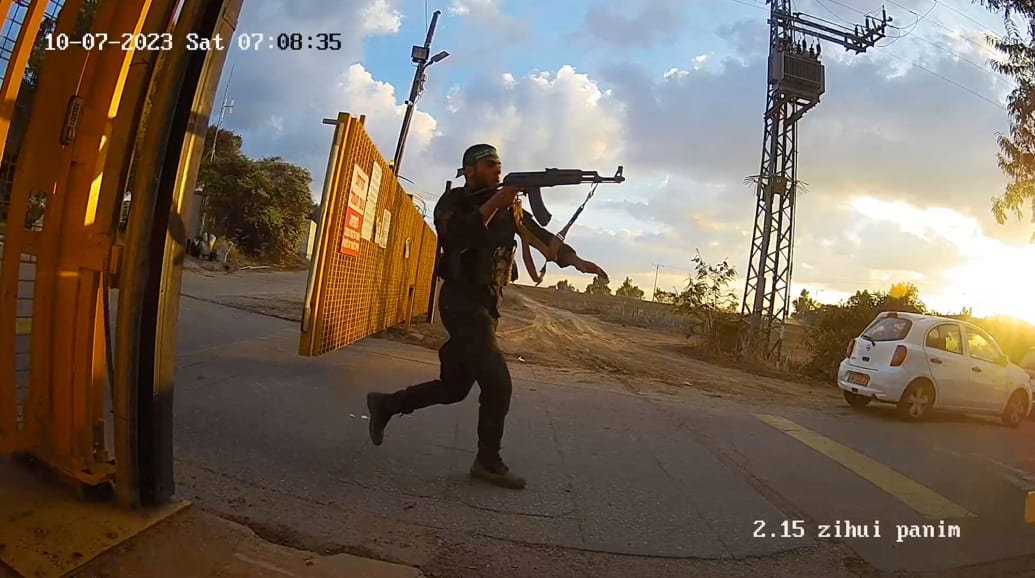 An armed man aims his rifle during the Oct. 7th attack by Hamas in Kibbutz Alumim, Israel.