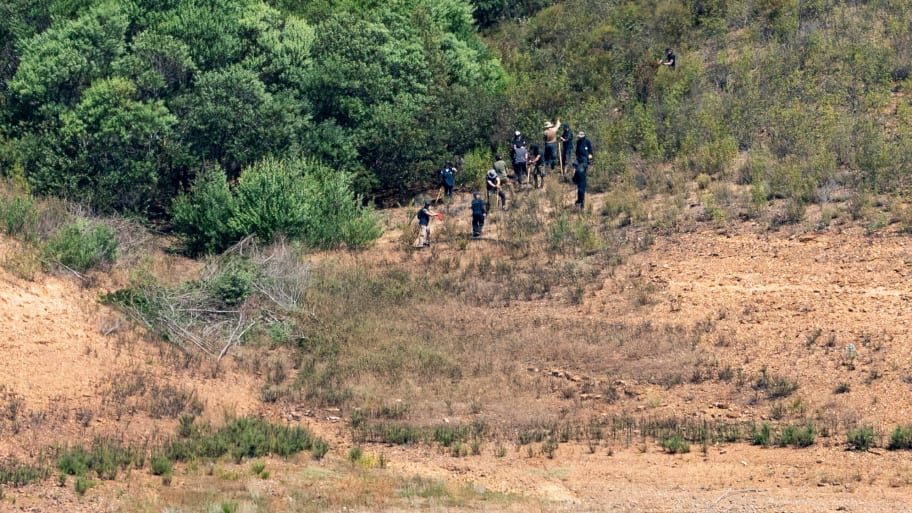 Police officers are seen at the site of a remote reservoir where search is underway for evidence related to the disappearance of Madeleine McCann, who went missing in the Portuguese Algarve in May 2007, in Silves, Portugal, May 25, 2023.