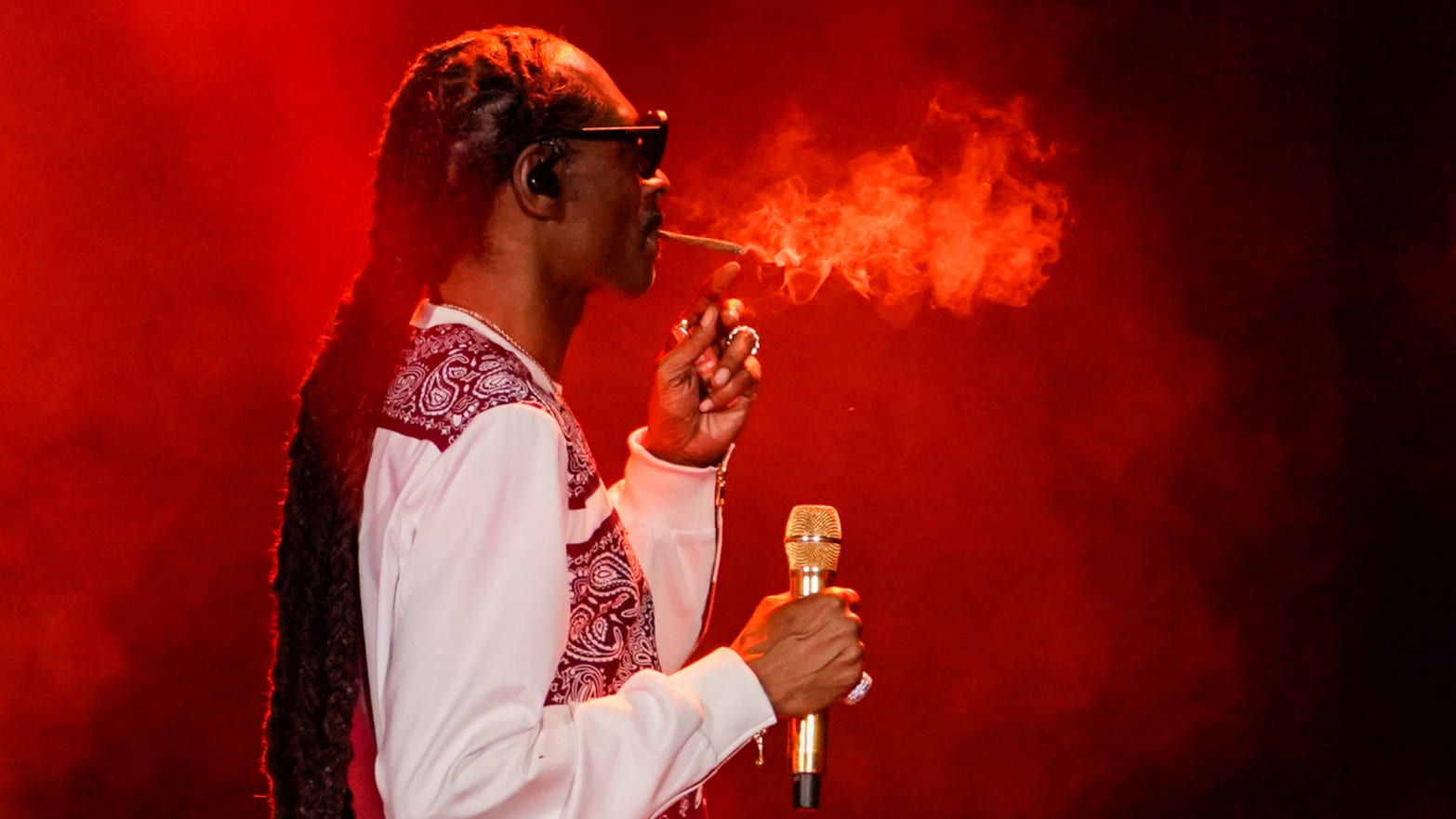 Rapper Snoop Dogg smokes as he performs during a celebration of hip hop in the Bronx at Yankee Stadium on Aug. 11, 2023.