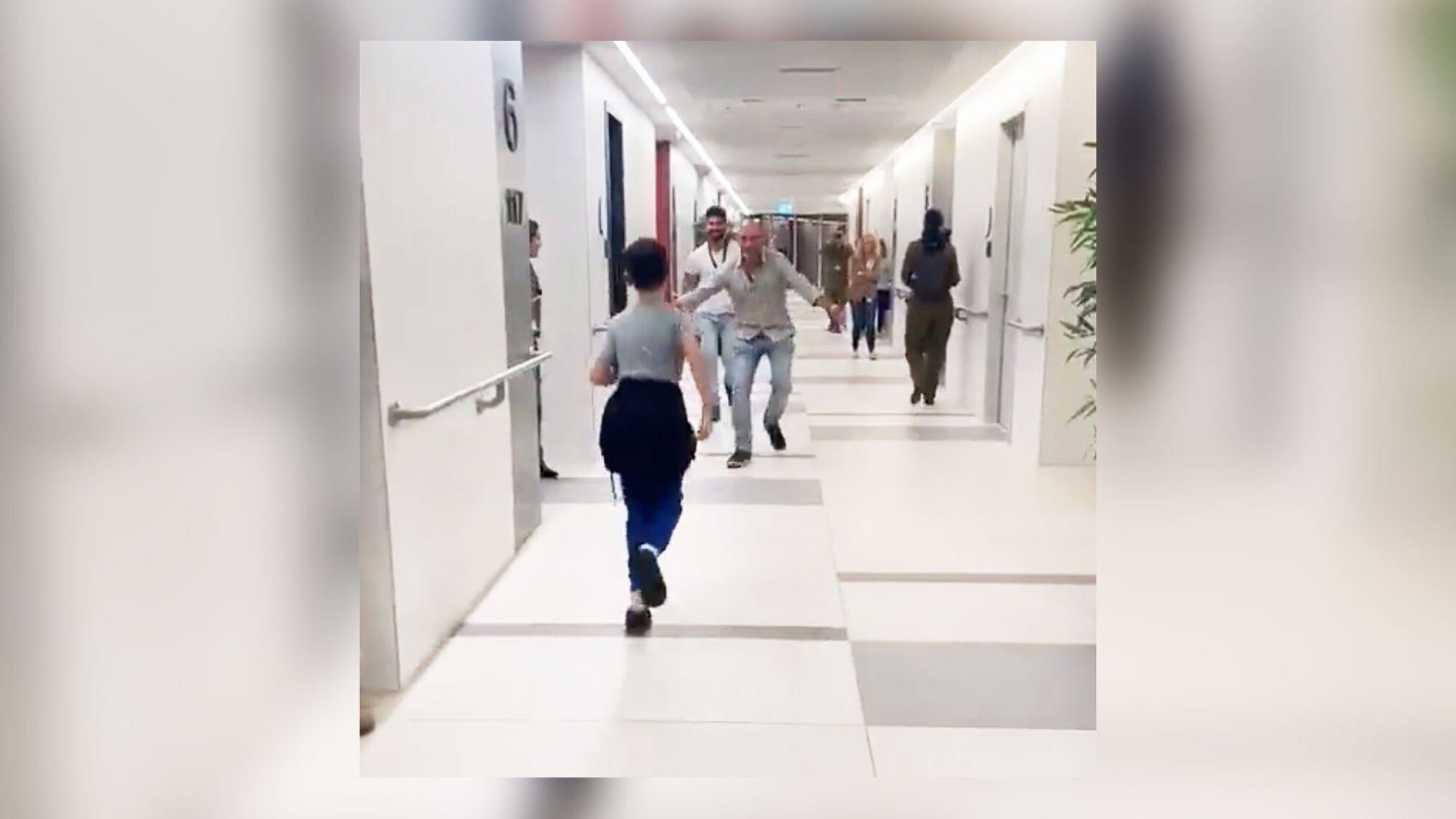 Ohad Munder runs down a hall to meet his father after being released as part of a prisoner exchange.