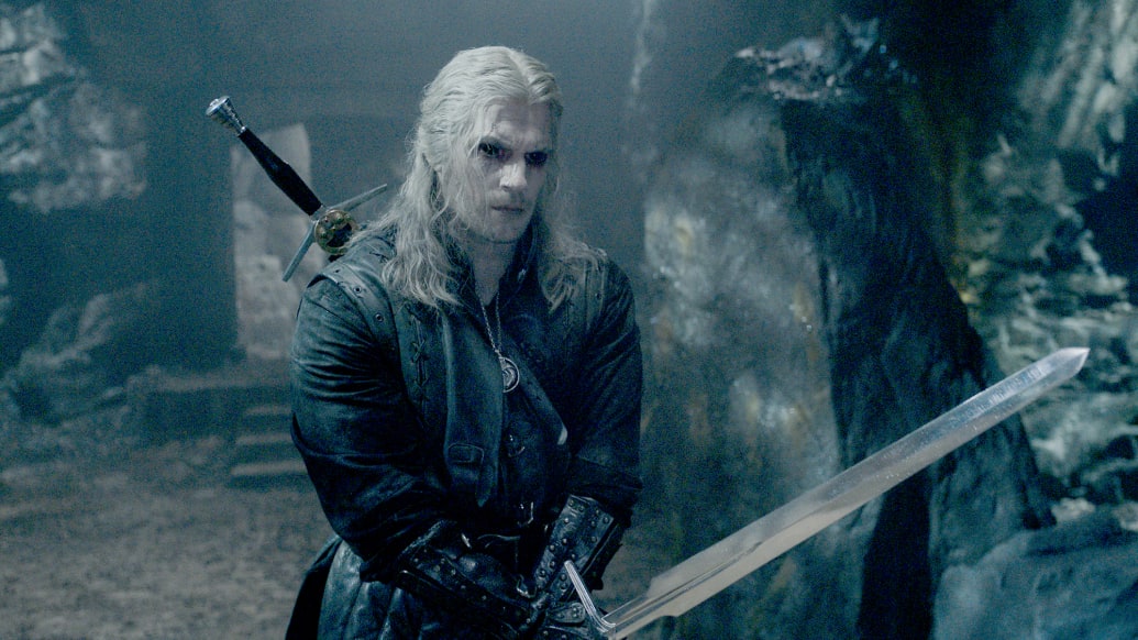Henry Cavill holds a sword in a scene from Netflix’s The Witcher Season 3.
