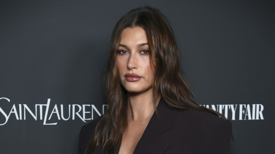 Hailey Bieber wearing a black suit on the red carpet.