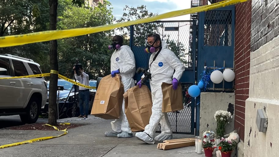 Members of the NYPD's Crime Scene Unit remove evidence from Divino Nino day care