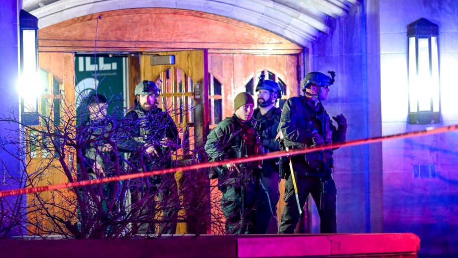 Police officers stand outside a dorm hall after the Michigan State shooting