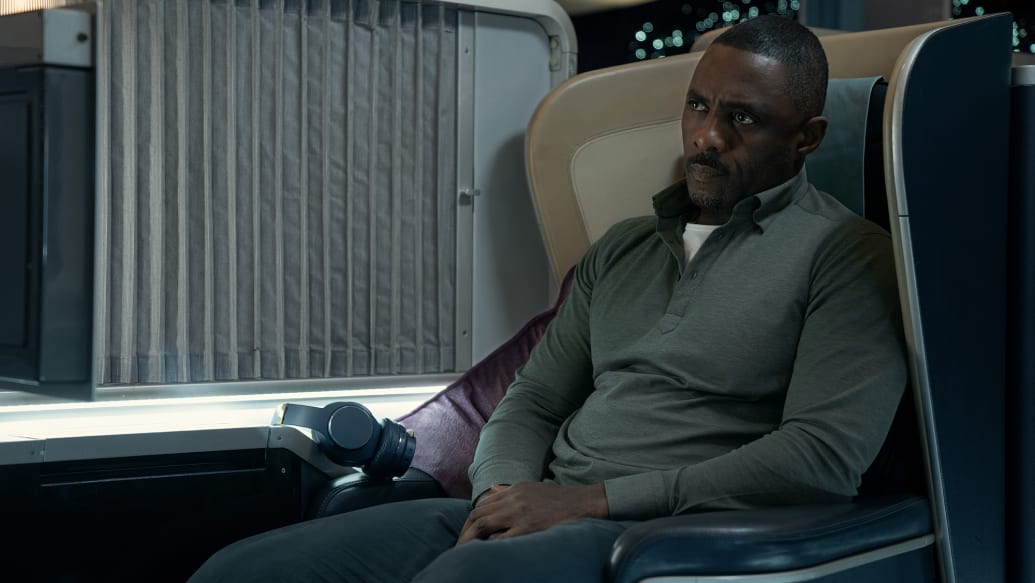 Idris Elba sits on a plane in a scene from Hijack.