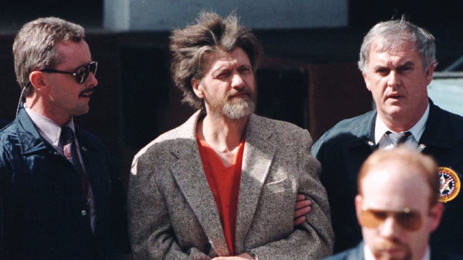 Theodore Kaczynski is led into federal court where he was charged with a single federal weapons violation April 4.