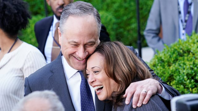 Kamala Harris and Douglass Emhoff embrace each other while smiling