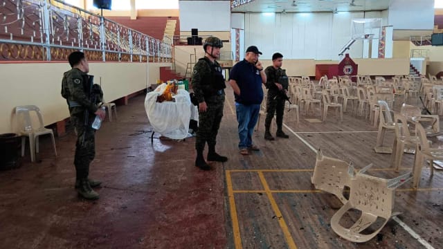 Lanao Del Sur Gov. Mamintal Adiong Jr. looks on as law enforcement officers investigate the scene of an explosion that occurred during a Catholic Mass in a gymnasium at Mindanao State University in Marawi, Philippines, Dec. 3, 2023.
