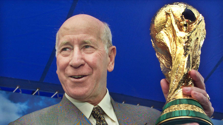 FIFA Ambassador and England soccer legend Bobby Charlton holds up the FIFA World Cup trophy in 2002.