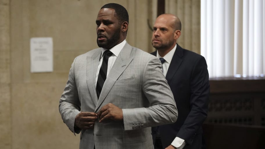 R. Kelly, left, stands in court before Judge Lawrence Flood at Leighton Criminal Court Building in Chicago