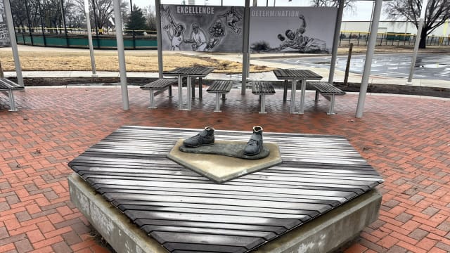 Shoes remain anchored to the pedestal where the rest of the Jackie Robinson memorial statue went missing after thieves stole it Wednesday night.