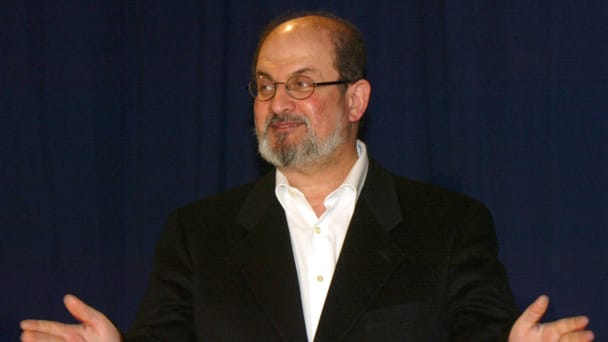 Salman Rushdie gestures to the audience in Vienna on April 15, 2002.