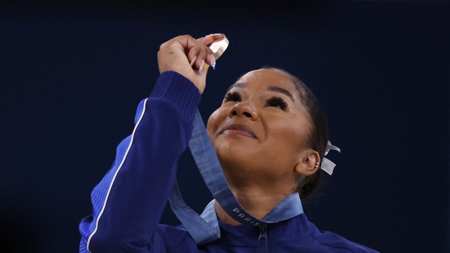 Bronze medallist Jordan Chiles of United States looks at her Olympic medal after getting third in the women's floor exercise.