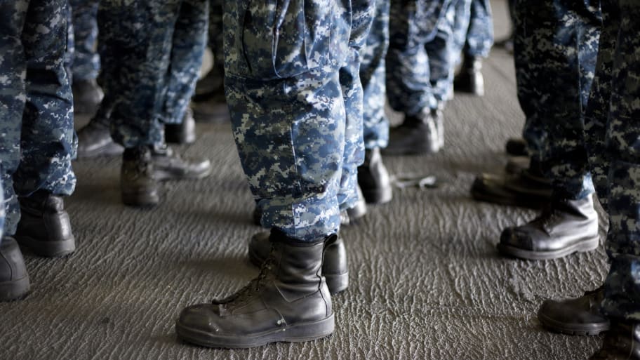 Stock image of sailors lining up on the USS Carl Vinson.