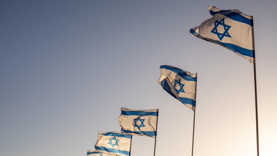 Several flags of Israel flying outside the historic Old City of Jerusalem in Israel.