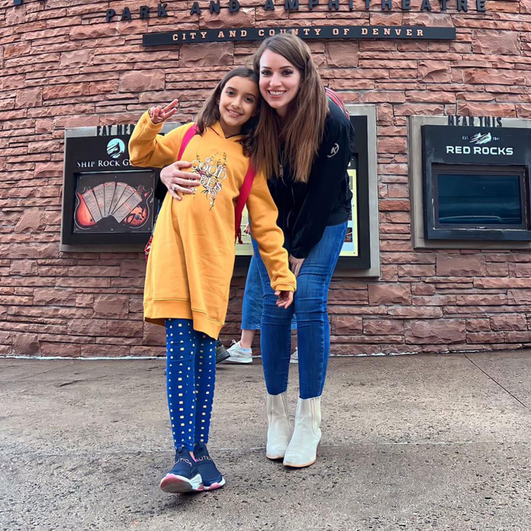 Bethany Alhaidari and her daughter Zaina pose for a picture in front of a concert venue.