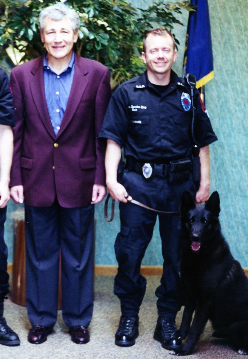 Former U.S. Senator Chuck Hagel, left, with Nebraska State Trooper Steve Rasgorshek and his K-9 partner Nero.