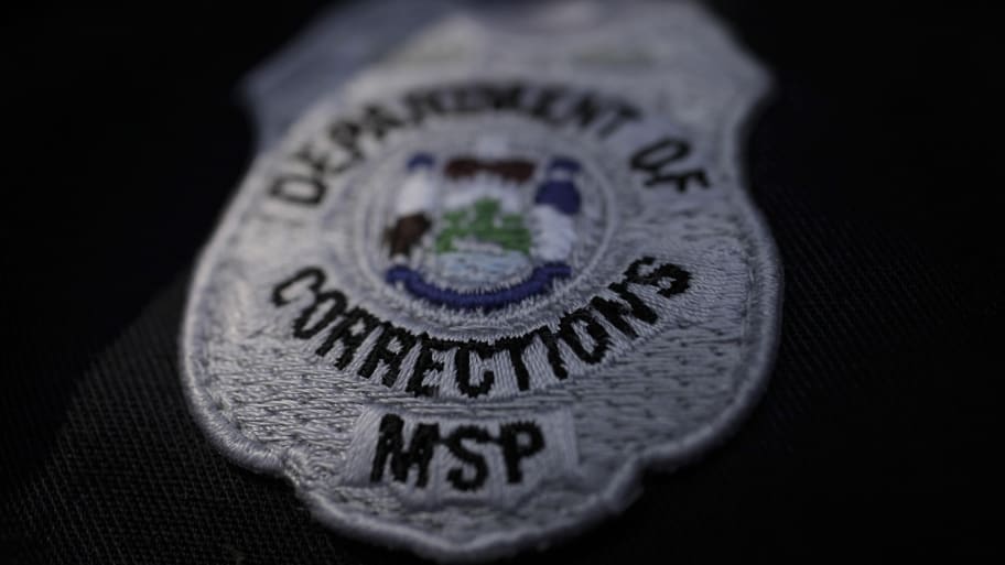 A Maine state prison guard uniform showing the seal of the Dept. of Corrections. 