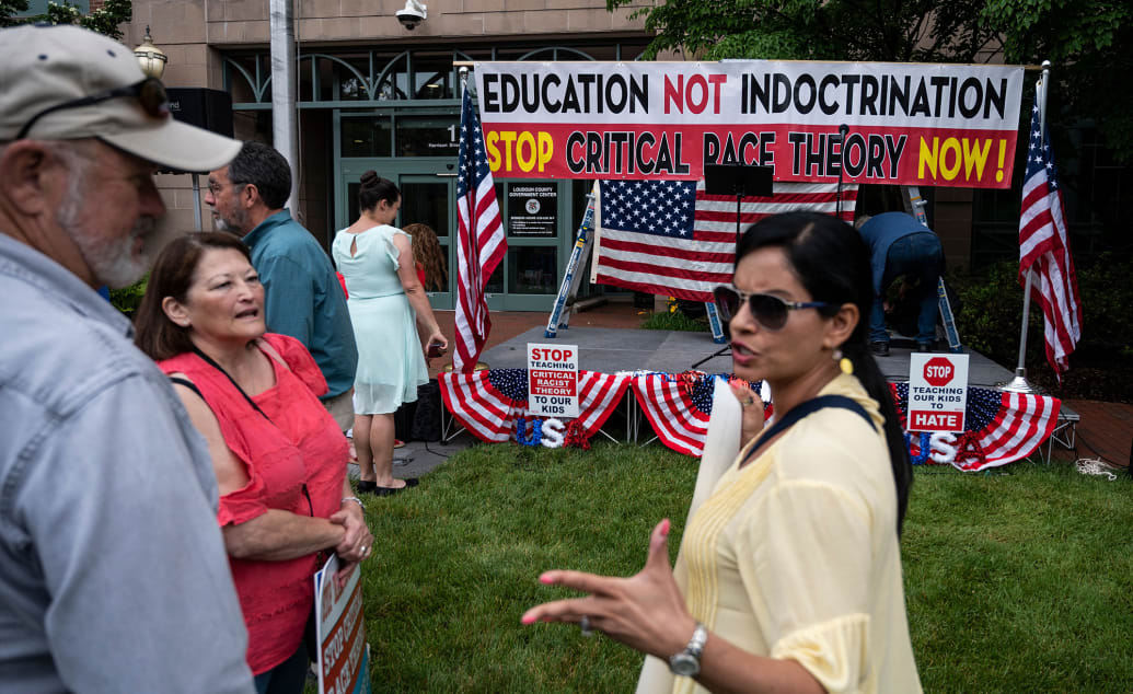 People talk before the start of a rally against "critical race theory" being taught in schools at the Loudoun County Government center in Leesburg, Virginia on June 12, 2021.