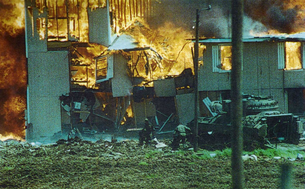 FBI agents rescue Ruth Riddle from the burning Branch Davidian building.