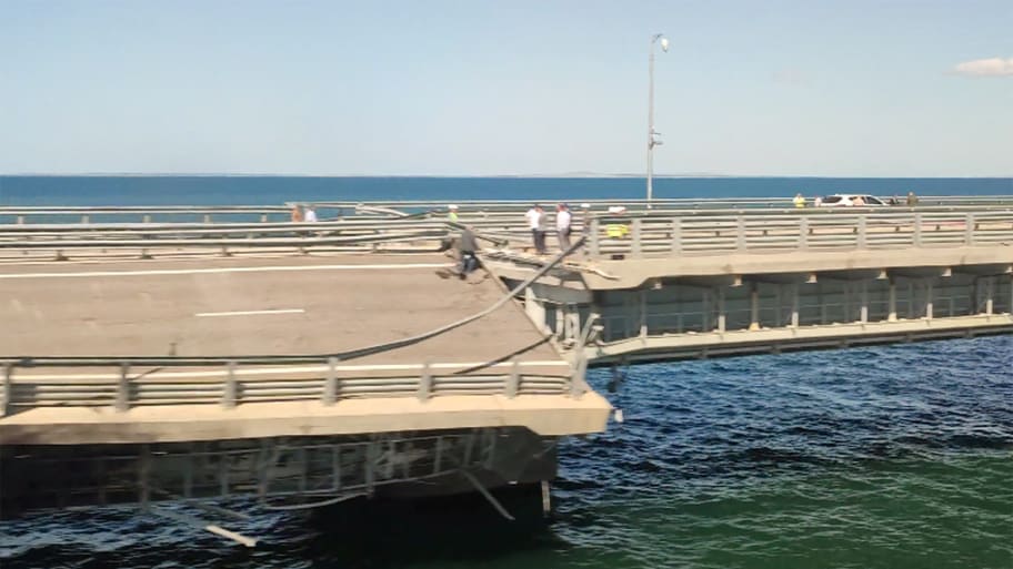The section of a road split and sloping to one side following an alleged attack on the Crimea Bridge, that connects the Russian mainland with the Crimean peninsula across the Kerch Strait, in this still image from video taken July 17, 2023. 