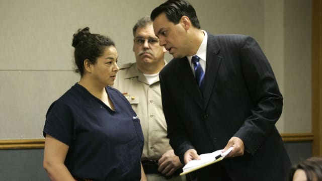 Anna Ayala speaks with her lawyer during a court hearing.