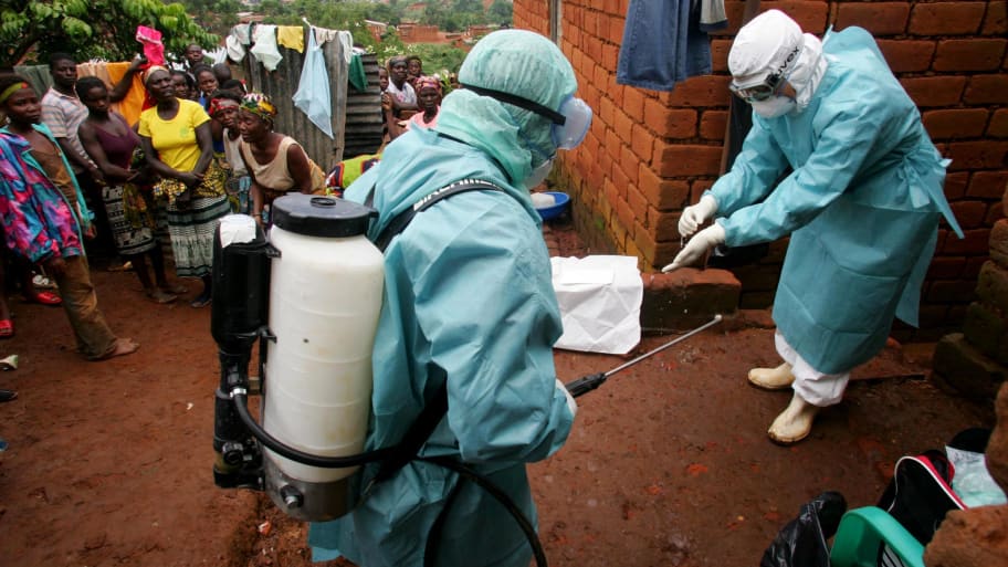World Health Organisation officials examine the home of a suspected Marburg virus victim in the northern Angolan town of Uige, April 19, 2005. 