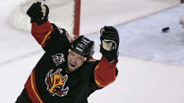 Chris Simon celebrates scoring a goal for the Calgary Flames.