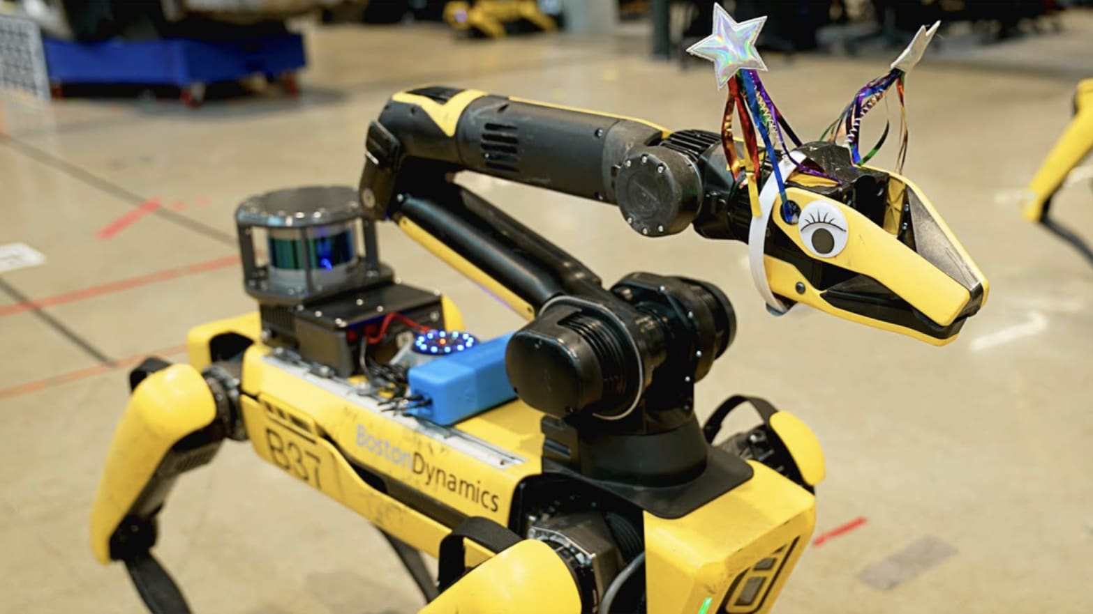 Boston Dynamics' Spot robot wearing googly eyes and a hat