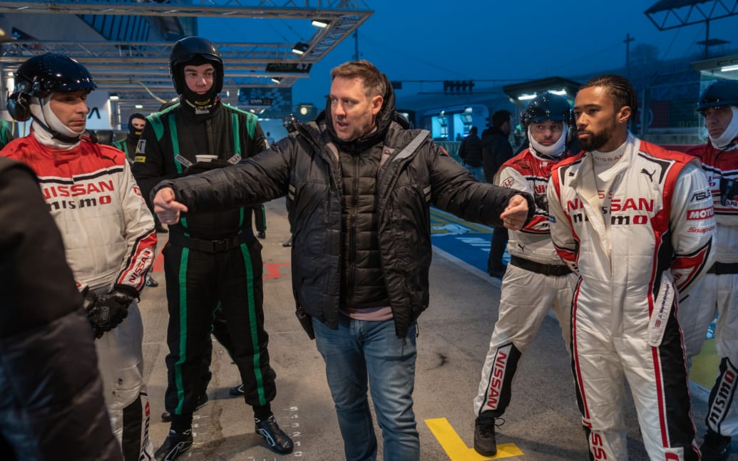 Director Neill Blomkamp (center) and the real Jann Mardenborough (right) on the set of Gran Turismo.