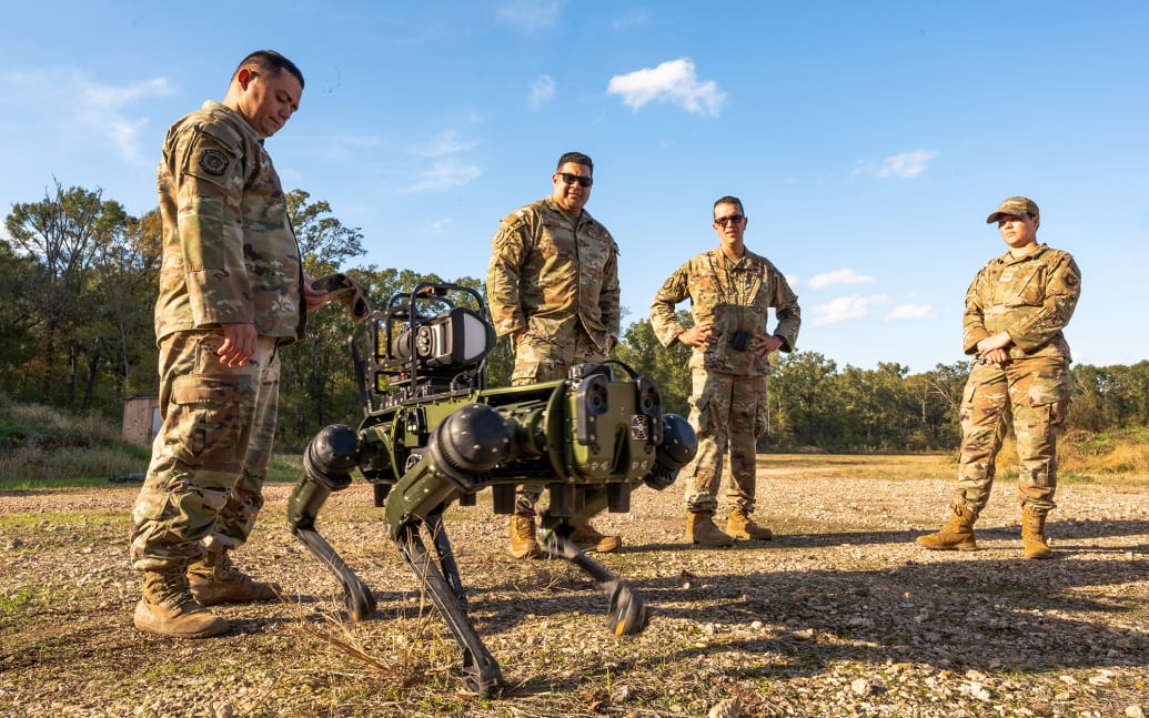 A team from the 2nd Civil Engineer Squadron monitors Atom a robot dog while remote controlling it on Nov. 6, 2023, at Barksdale Air Force Base, Louisiana.
