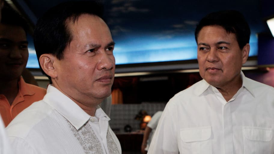 Apollo Quiboloy (L) welcomes senator and presidential candidate Manuel Villar (C) and his vice-presidential candidate Loren Legarda during his 60th birthday celebration in Davao city, southern Philippines.