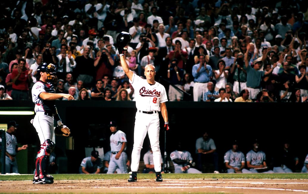 Infielder Cal Ripken Jr. of the Baltimore Orioles tips his batting helmet to the fans after breaking Lou Gherig's record.