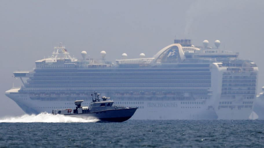  A patrol boat sails past the Princess Cruises' Ruby Princess cruise ship as it docks in Manila Bay during the spread of the coronavirus disease (COVID-19), in Cavite city, Philippines, May 7, 2020. 
