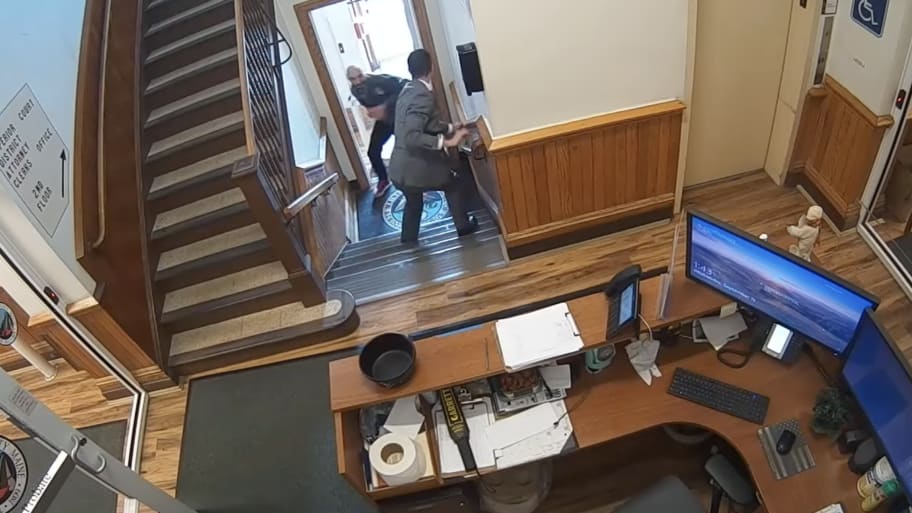 A video still shows a handcuffed Nicholas Carter facing a court official just before he turns and flees a courthouse in Skowhegan, Maine.