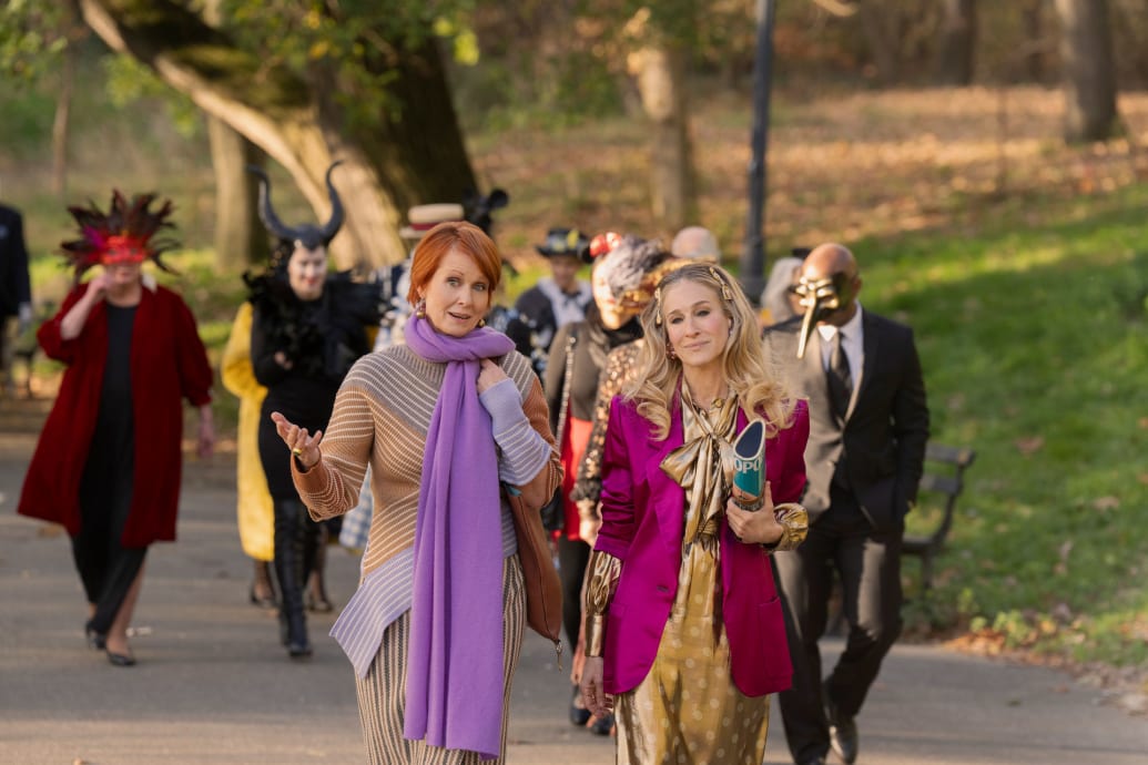 A still of Cynthia Nixon as Miranda and Sarah Jessica Parker as Carrie in And Just Like That. 