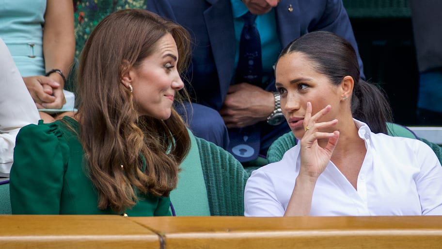 Catherine, Duchess of Cambridge talks with Meghan, Duchess of Sussex in 2019