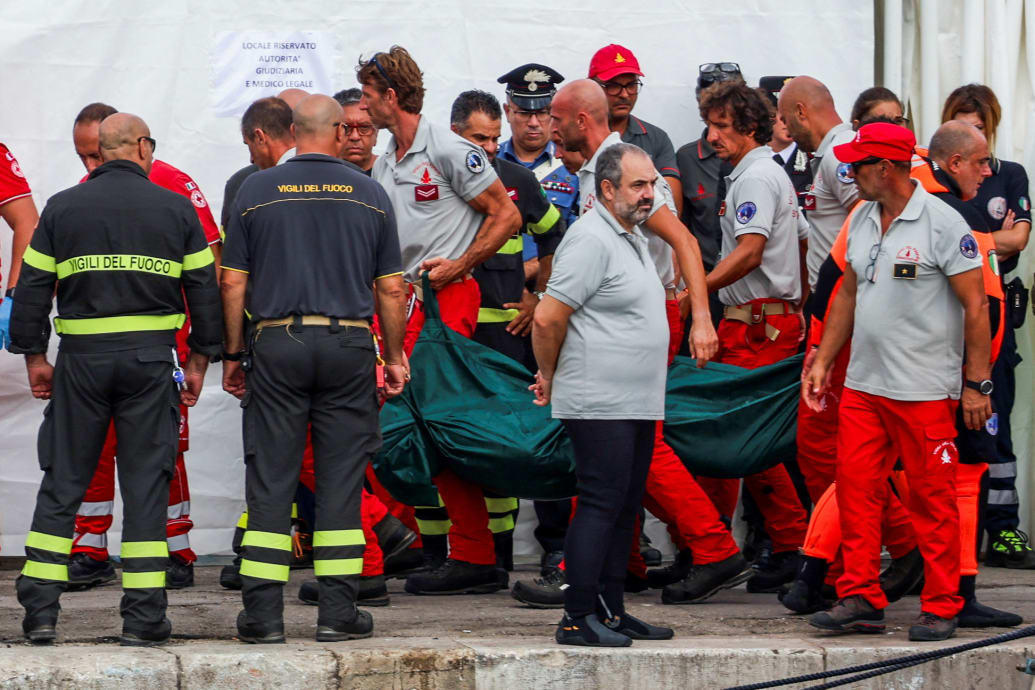 Authorities carry a green body bag