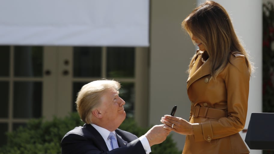 First lady Melania Trump receives a pen from President Donald Trump after he signed the Be Best initiatives proclamation in the Rose Garden of the White House in Washington, D.C., May 7, 2018.