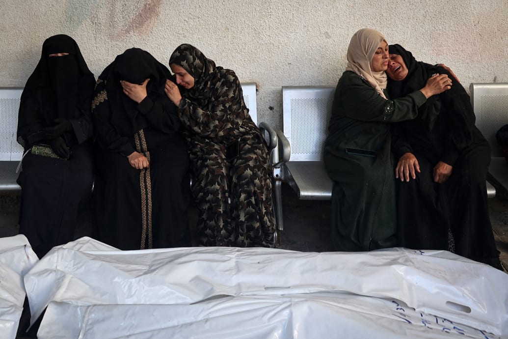 Relatives of Palestinians killed in Israeli bombing mourn.