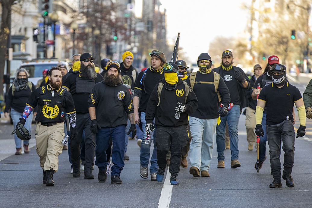 Members of the Proud Boys march down a street in Washington, DC, in support of Donald Trump.